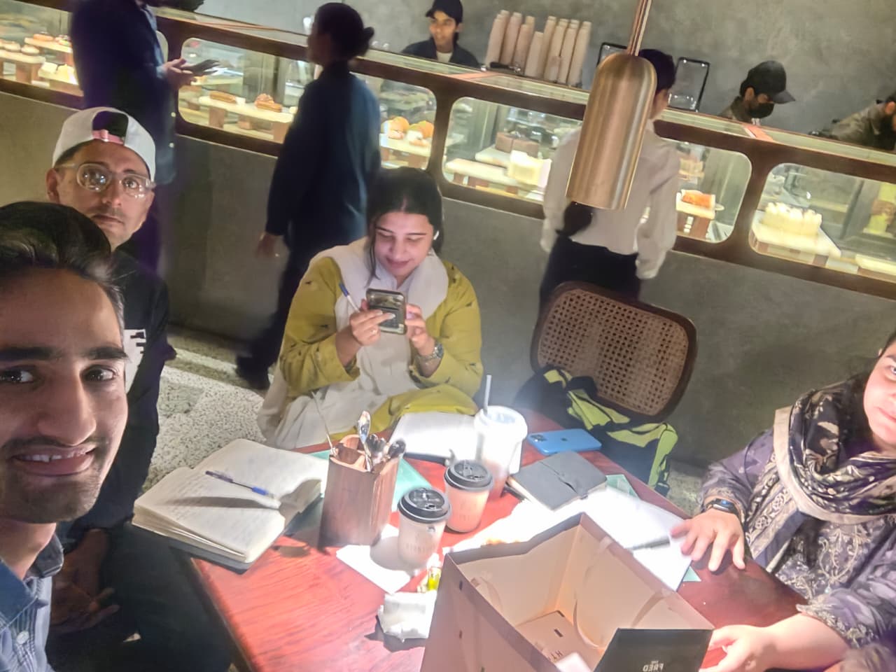 Coffee and notebooks with the team at a café