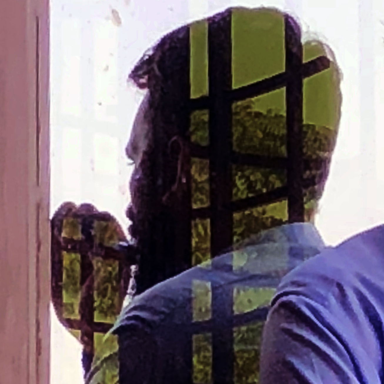 Silhouette through a window grid